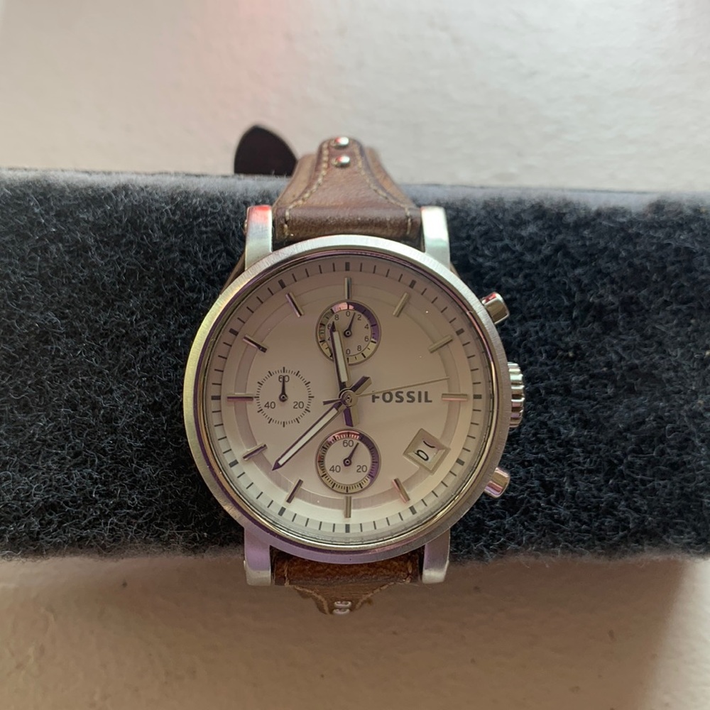 Fossil watch with a tan leather band and cool face with a date indicator.